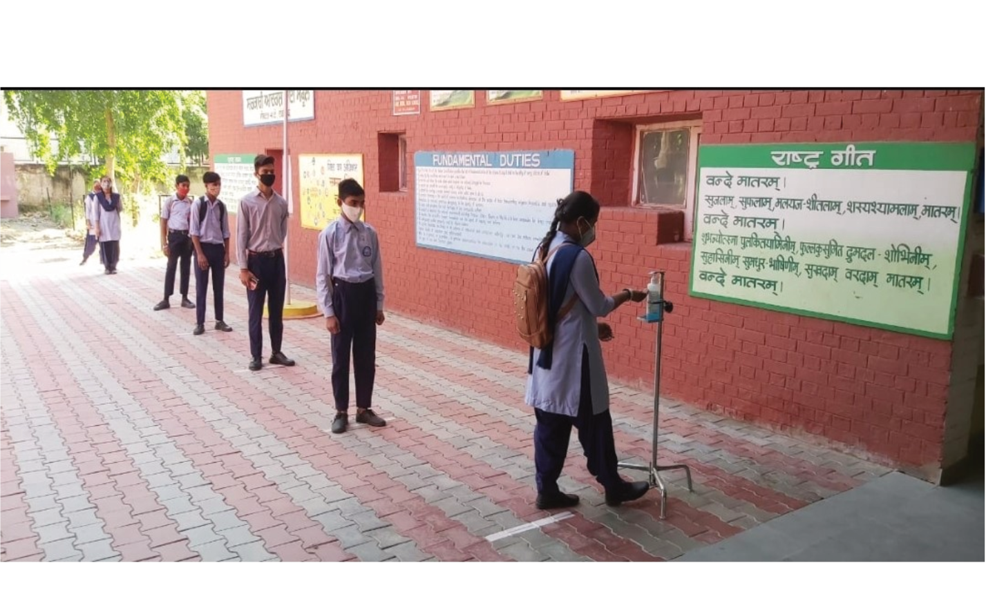 Students sanitizing hands